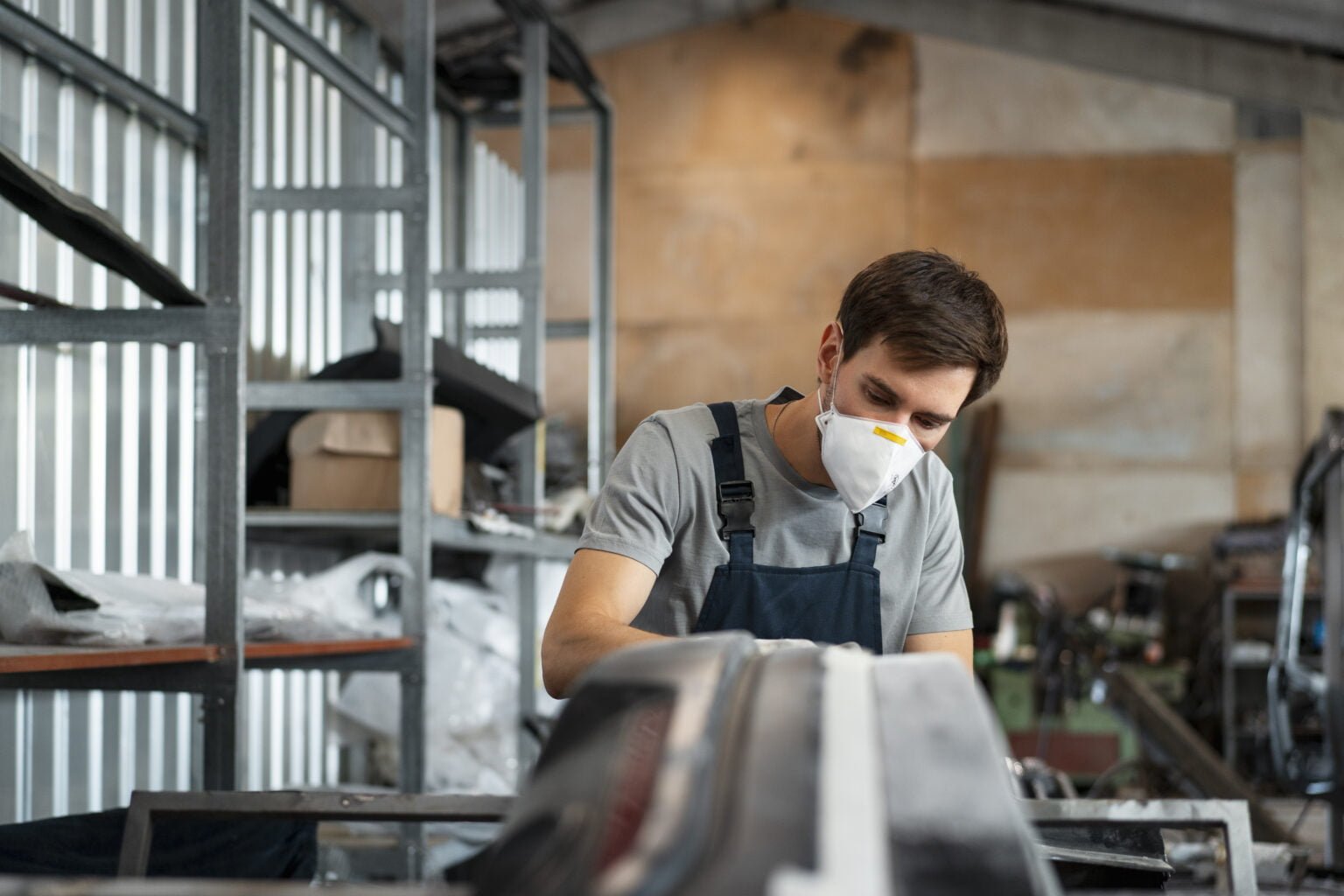 male-painter-overalls-doing-his-work-car-shop